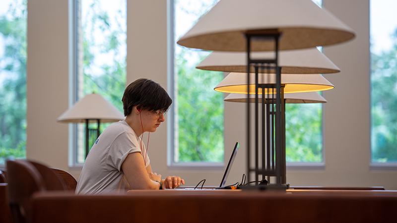 Student studying at library table