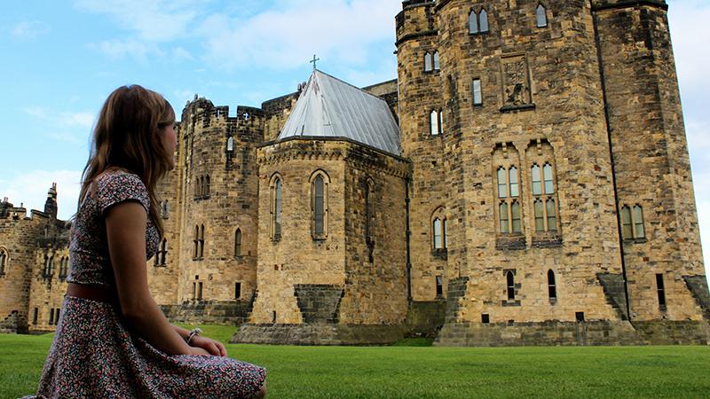 Girl looking at Alnwick Castle